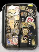 A group of embroidered insignia including various police forces, metal badges, etc.