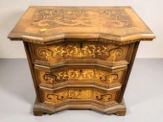 A 20th century Dutch walnut and satinwood marquetry small three drawer chest, width 64 cm.