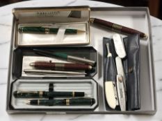 A group of fountain and ballpoint pens including Parker, several folding knives, etc.