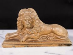 A Victorian salt glazed pottery lion doorstop, length 44 cm.