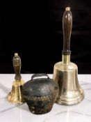 A brass bell, height 31 cm, a smaller bell and a cow bell.
