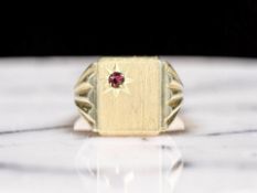 A gent's gold signet ring with inset synthetic ruby, stamped 750, size V.