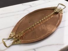 An Arts & Crafts hammered copper and brass twin handled oval serving platter, width 58 cm,