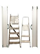 An aluminium step ladder, a wooden ladder and a pair of car lamps.