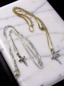 A silver necklace with blue gemstone crucifix pendant,