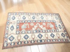 An Afghan / Caucasian design rug, 242 cm x 145 cm.