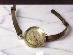 A lady's continental gold open faced fob watch, adapted as a wristwatch,