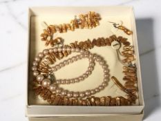 An Organics boxed silver-mounted garniture of Biwa stick pearls comprising necklace,