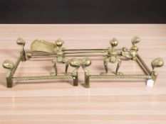A Victorian brass two section fire curb, a pair of fire dogs and a companion set.