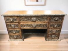 A Victorian heavily carved oak ten drawer chest, probably the upper section of a desk,