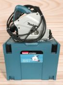 A Makita 165 mm SP6000 circular saw with box, together with a pair of Makita router boards.