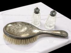 A silver-backed dressing table brush and two silver-mounted sifters