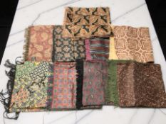 A group of decorative patterned scarves.