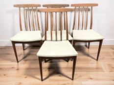A set of four teak spindle back dining chairs.