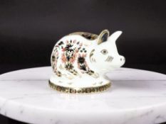 A Royal Crown Derby Piglet paperweight, with gold stopper and original box.