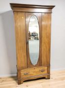 An Edwardian inlaid mahogany mirrored door single door wardrobe, 105 cm x 47 cm x 195 cm.