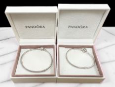 Two Pandora charm bracelets with boxes