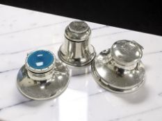 Three silver inkwells, one with blue guilloche enamel lid, diameter 7cm.