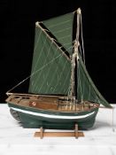 A large remote control scale model of the single masted sailboat 'Nellie', length 77 cm,