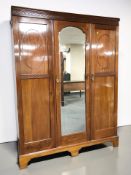 An Edwardian mahogany triple door compactum wardrobe, 154 cm x 54 cm x 203 cm.