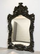 A contemporary mirror in black composition frame, height 140 cm.