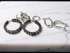 A group of gem set hoop earrings stamped 925.