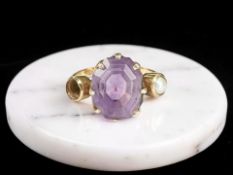 An amethyst and seed pearl ring, one pearl deficient, stamped 18C,