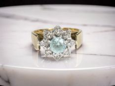An 18ct gold blue zircon and diamond cluster ring, size M½ CONDITION REPORT: 5.