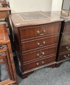 A reproduction mahogany two drawer filing pedestal with tooled leather inset top,