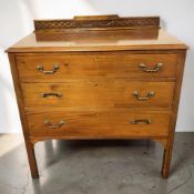 An Edwardian walnut three drawer chest, width 92 cm.
