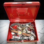 An enamelled cash tin of mixed wrist and pocket watches, including Ingersoll, Sekonda,
