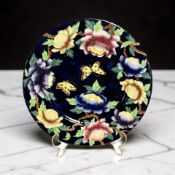A Maling lustre cabinet plate depicting butterflies above chrysanthemums, diameter 29 cm.