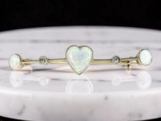 An Edwardian diamond and opal bar brooch, width 49mm.