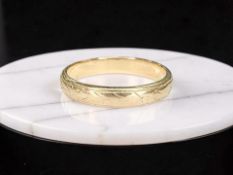 A gold band ring, stamped 18C, size M½. CONDITION REPORT: 3.