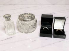 A silver dress ring set with coloured gemstones,