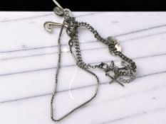 A silver charm bracelet, plus one other.