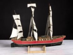 A large remote control scale model of a three masted ship, length 96 cm, on wooden stand.