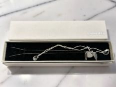 A Karine & Co silver winged heart necklace, and a further tear drop pendant necklace.