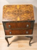 A 20th century figured walnut lady's bureau, width 60 cm.