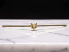 A 9ct gold fox head bar brooch with ruby-inset eyes, width 7.5cm.