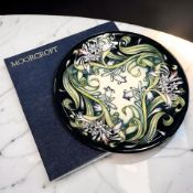 A Moorcroft Isis pottery plate, diameter 26 cm, boxed.
