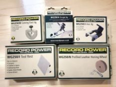 Five Record Power workshop tools in boxes including honing wheel, tool rest, axe jig, etc.