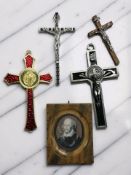 A group of four decorative crucifixes, one marked 'Made in Italy',