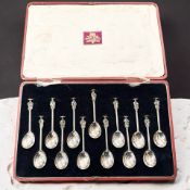 A set of thirteen silver figural teaspoons, Thomas Bradbury & Sons, Sheffield 1916, in case.