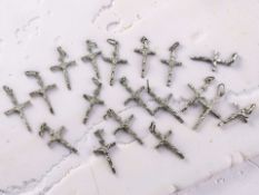 A group of sterling silver crucifix pendants. CONDITION REPORT: 33.9g.