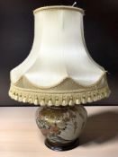 An oriental earthenware bulbous lamp base with shade, height 66 cm.