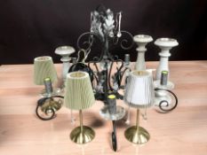 A contemporary chandelier, three rechargeable table lamps and three candle stands.
