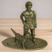 A brass figure of a man in flat cap with dog, height 19 cm.
