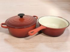 A Le Creuset enameled cast iron twin handled cooking pan with lid, diameter 20 cm excluding handles,