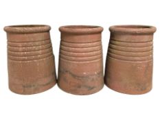 Three terracotta chimney pots, height 40 cm.